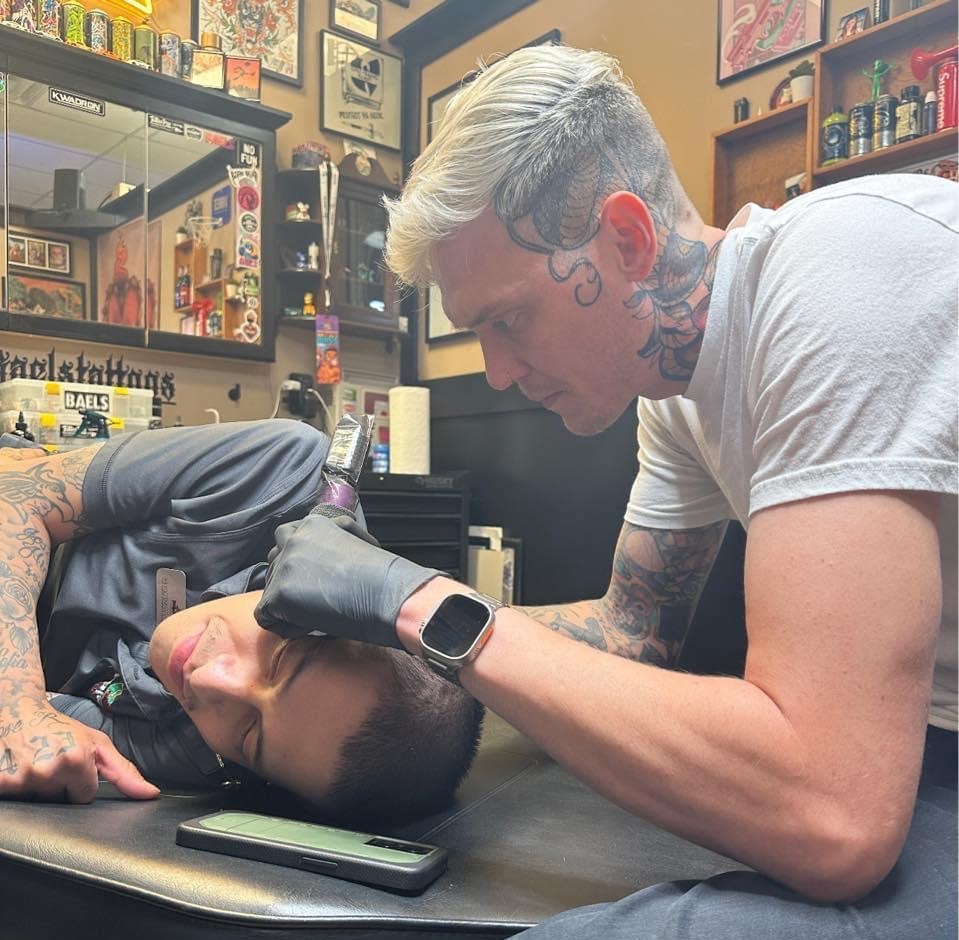 Baels tattooing a client at Flying Tiger Tattoo