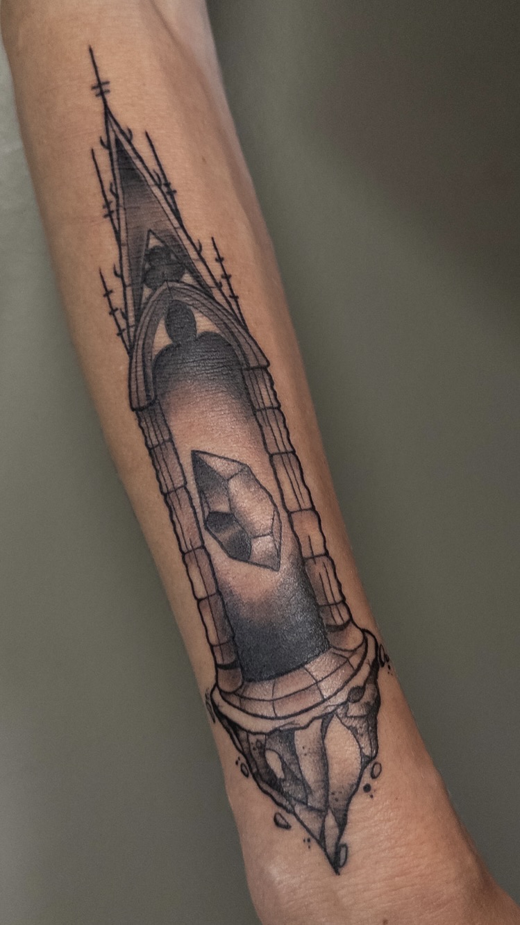 Black and grey cathedral window with shadowed figure illustrative tattoo