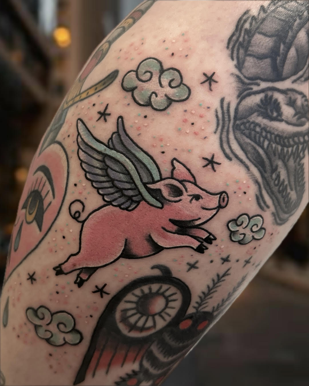 Traditional flying pig with angel wings tattoo