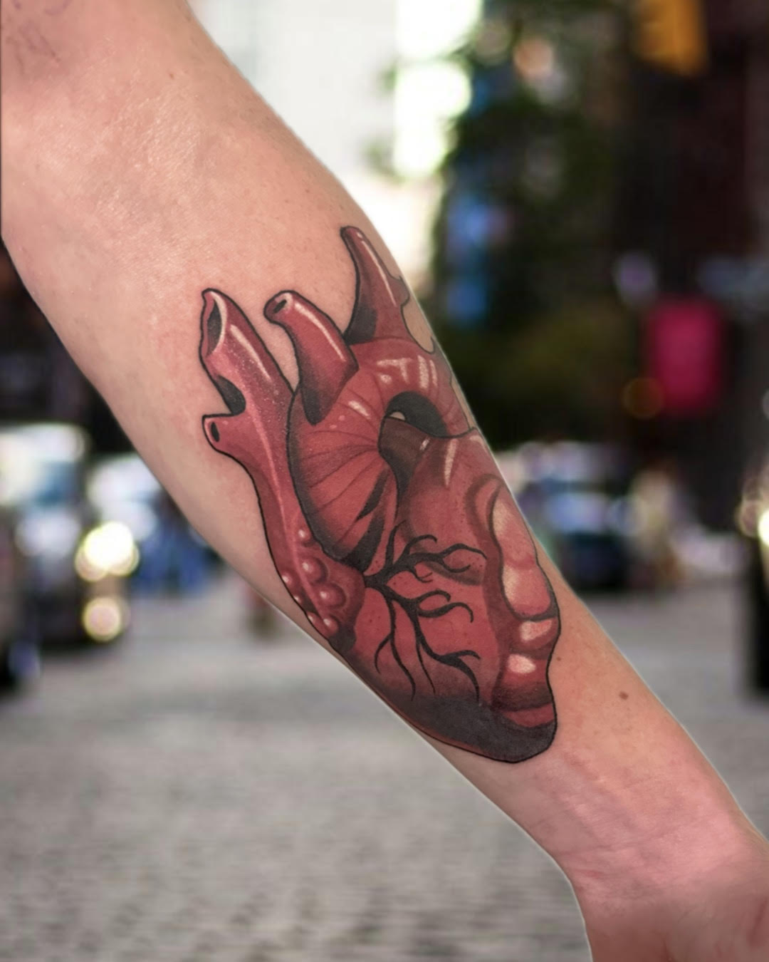 Neotraditional anatomical heart tattoo in deep red